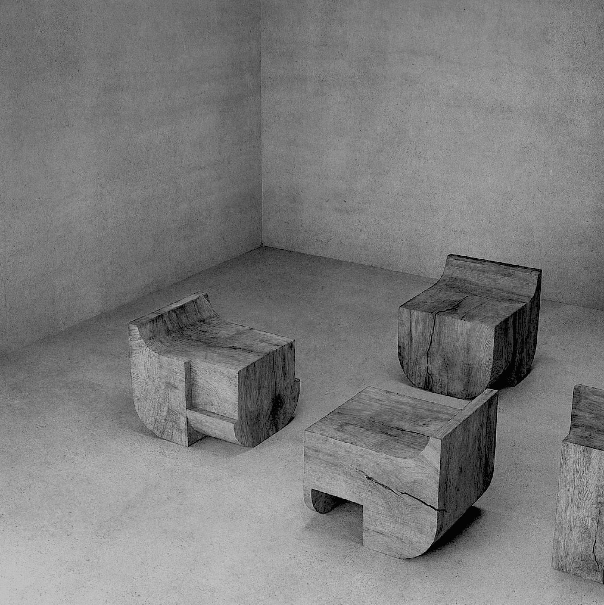 Sculptural monolithic chairs carved from solid wood and ebonized, designed by artist Isac Elam Kaid.