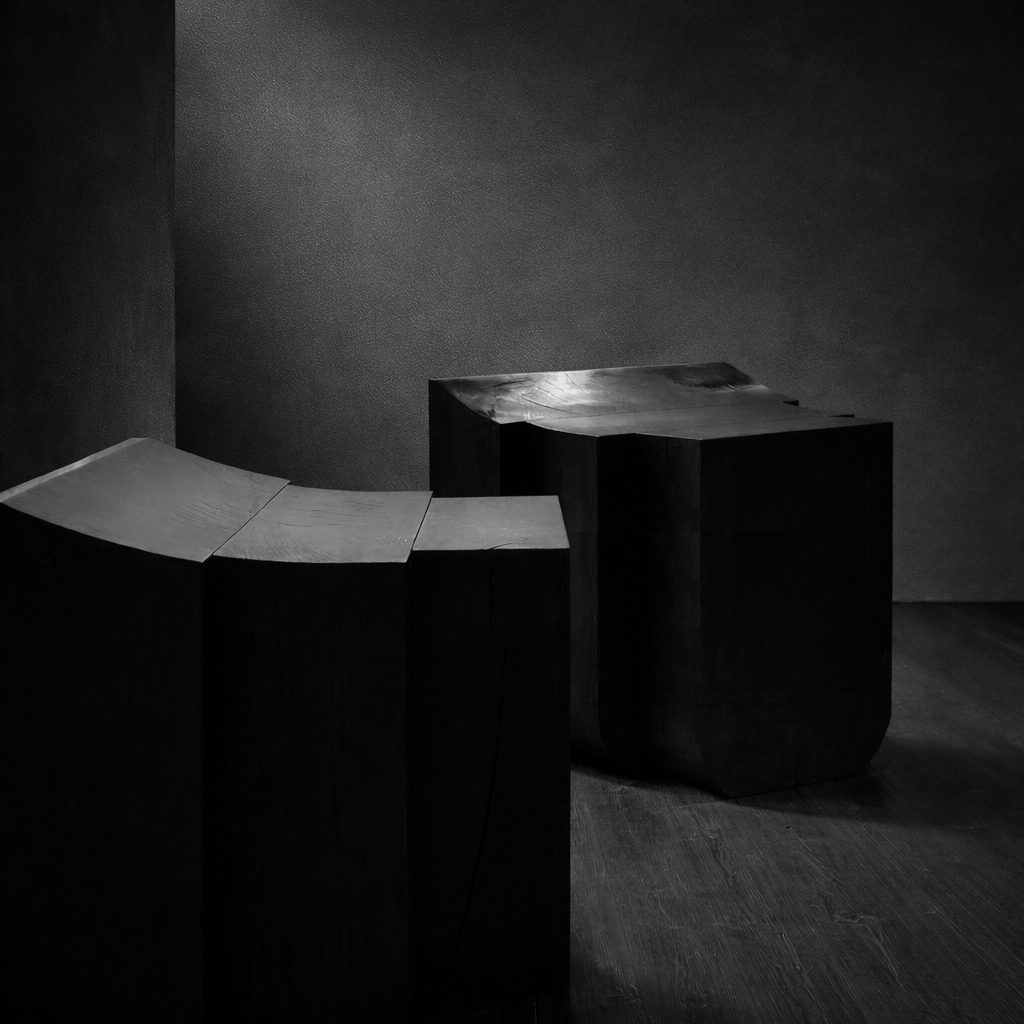 Monolithic chair by Isac Elam Kaid carved from European ash with a planar cut and ebonized finish.