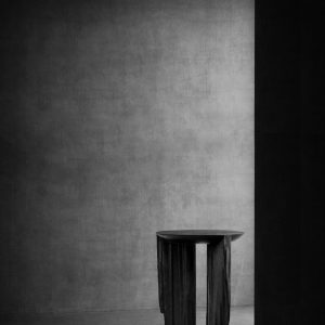 Sculptural table by Isac Elam Kaid formed from ebonized reclaimed timber with fractured vertical supports