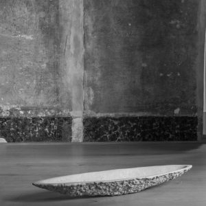 K2130 sculptural stone vessel by Isac Elam Kaid with fractured perimeter and shallow basin form.