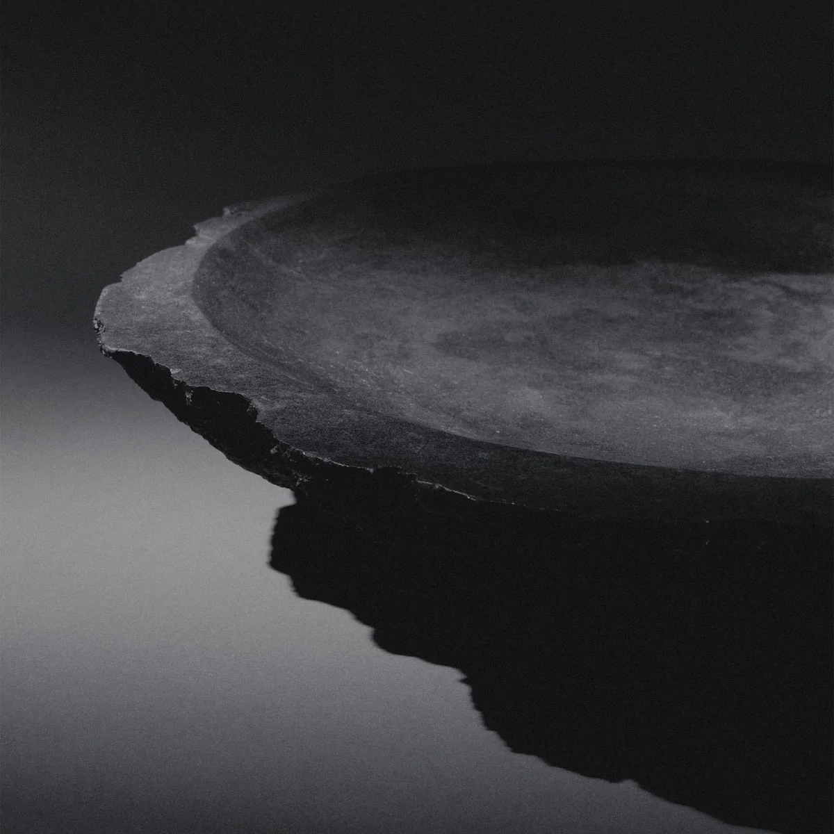 Collectible sculptural bronze vessel artifact by Isac Elam Kaid with irregular broken rim and polished interior basin.