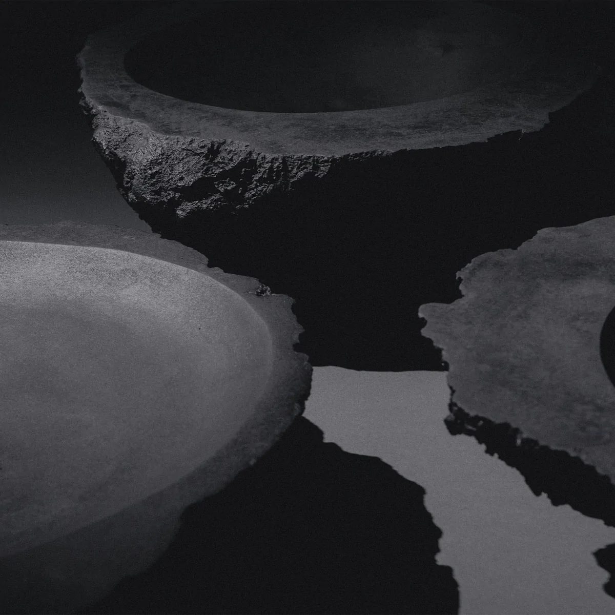 K25-2203 sculptural bronze vessel artifact by Isac Elam Kaid with fractured irregular rim and smooth basin interior.
